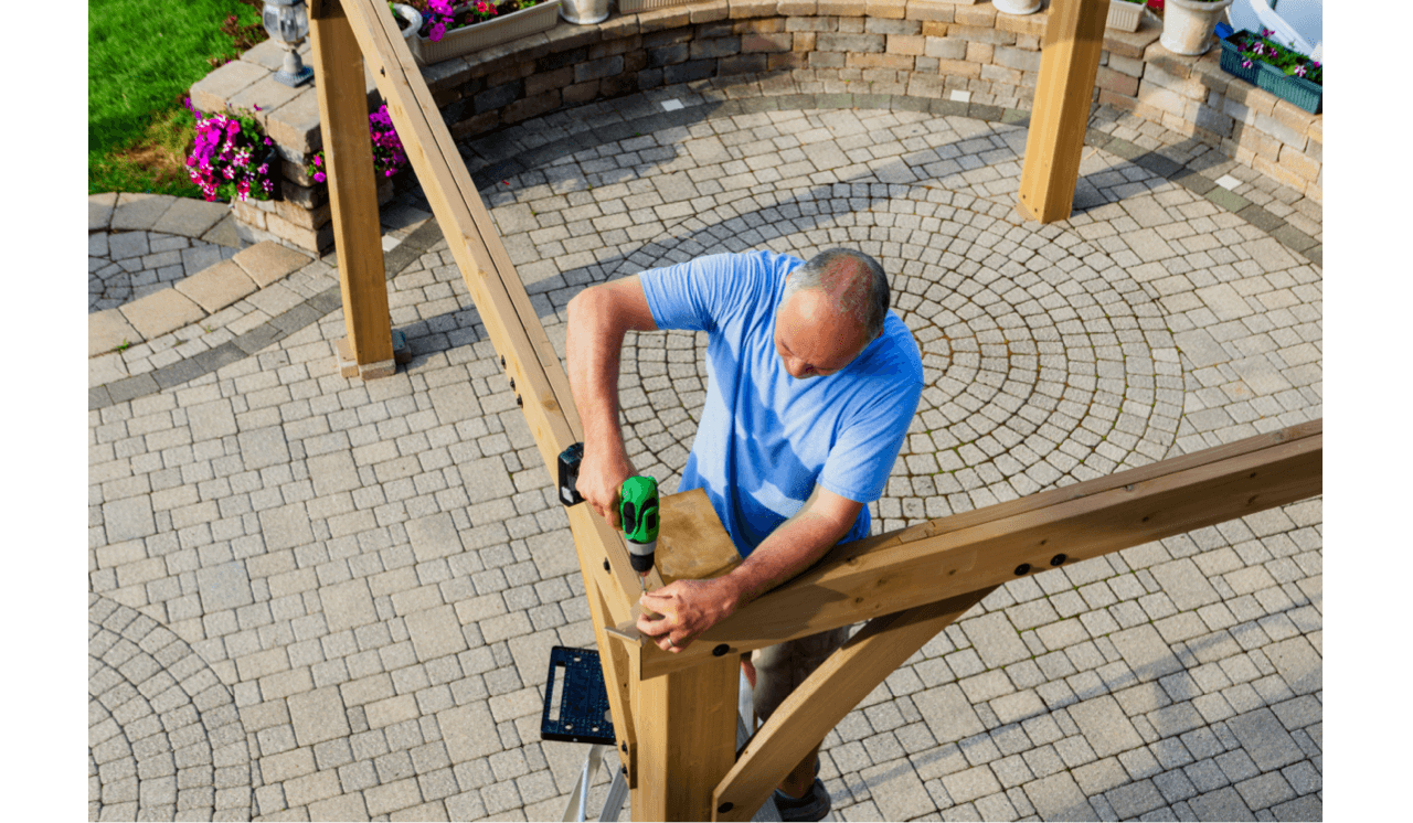 Homeowner building gazebo in backyard